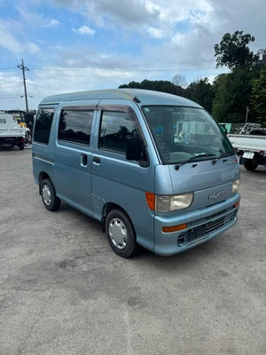 Light blue Daihatsu Hijet kei van parked outdoors